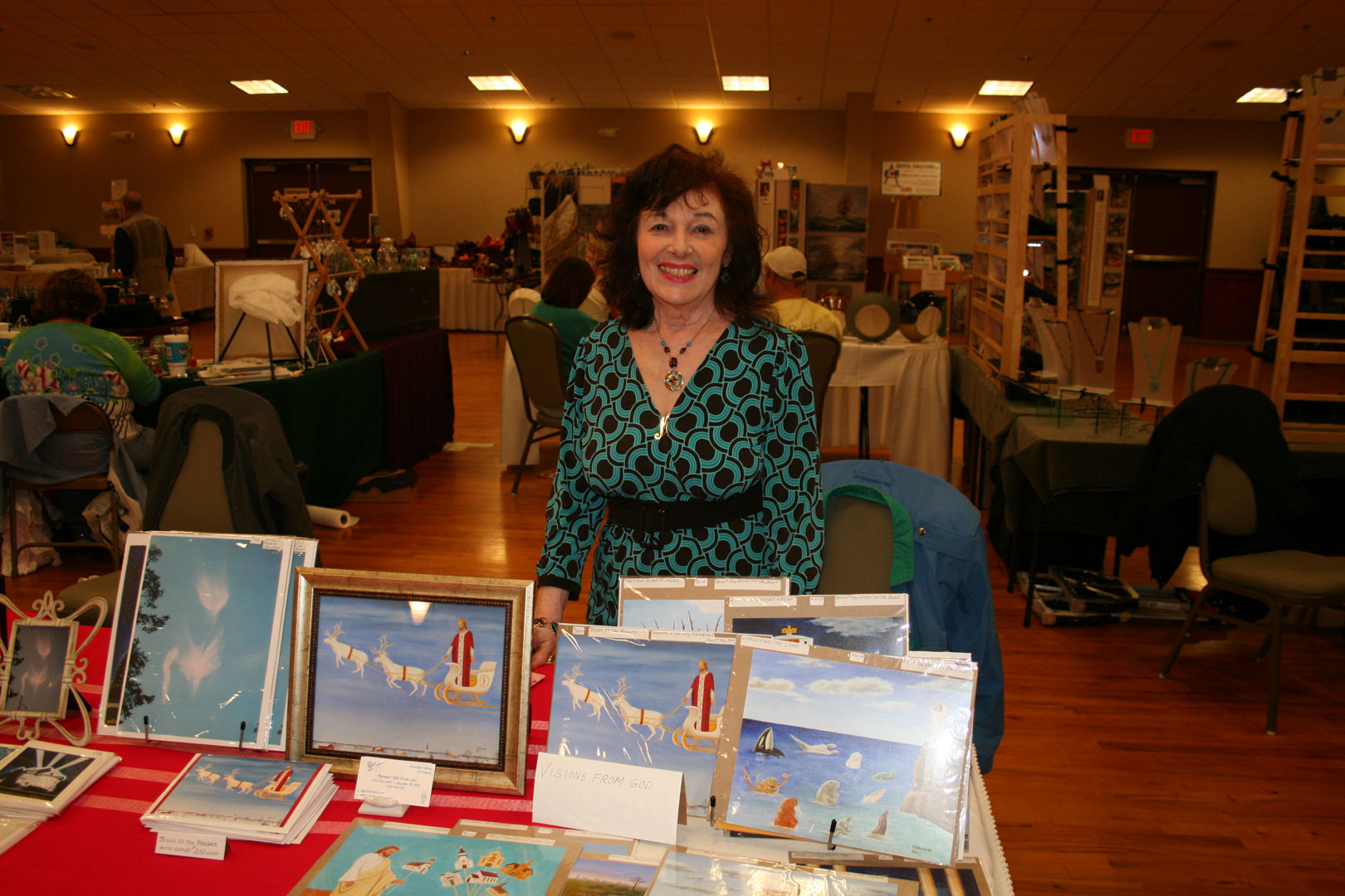 Marianne Ball at her display booth, surrounded by her angel artwork and porcelain pieces